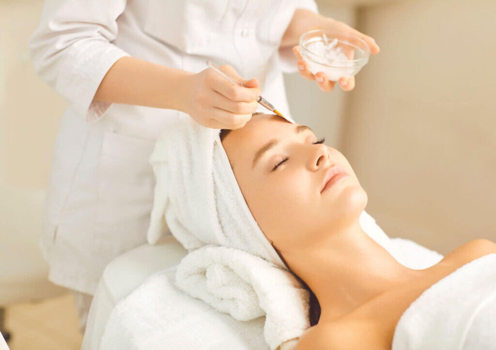 Woman in a towel getting a facial